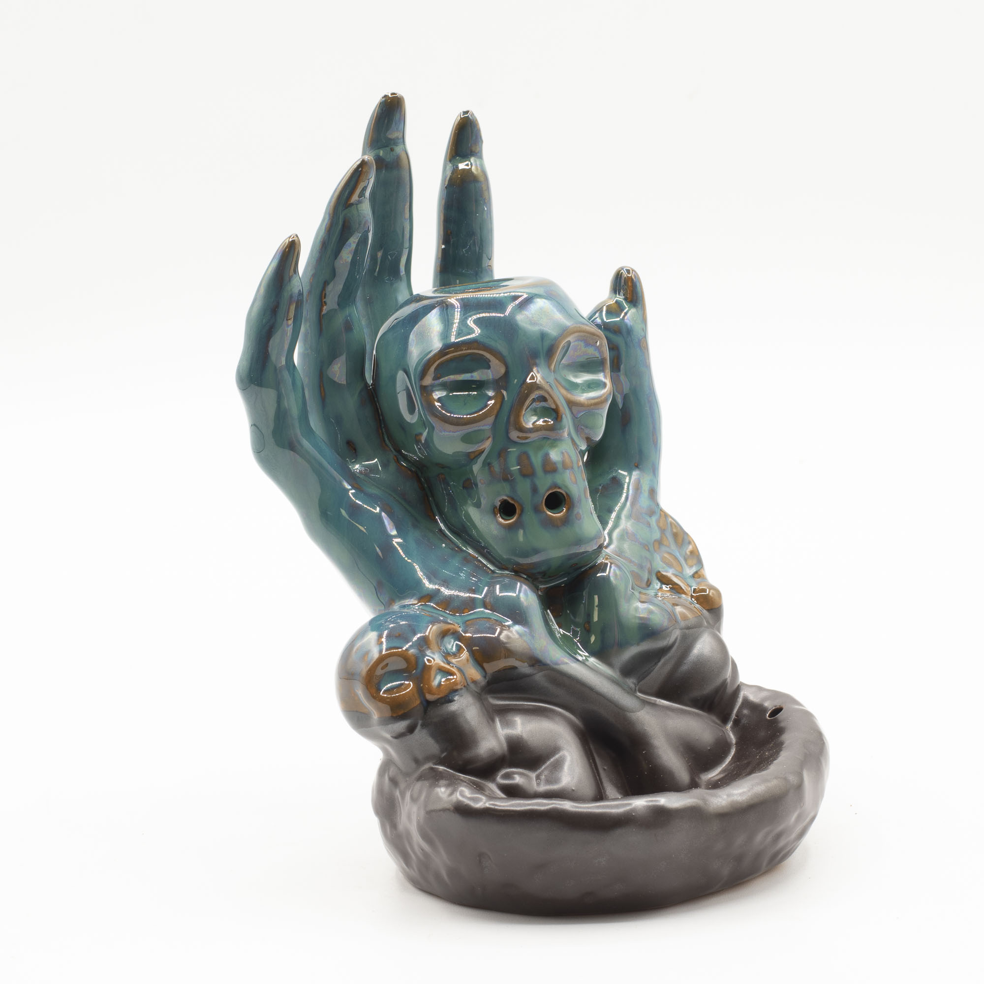 Add a dramatic touch to your space with this Skull in Hand backflow incense burn